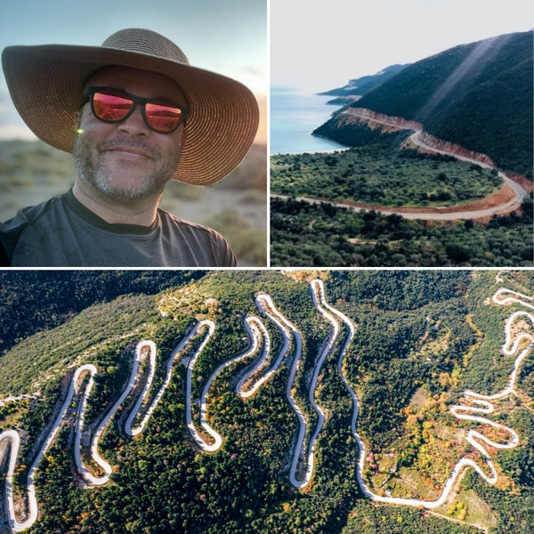 Self-portrait of the experienced motorcycle tour author/planner, positioned next to stunning aerial views of Greece's extreme mountain switchbacks and scenic winding coastal roads, confirming tested routes.